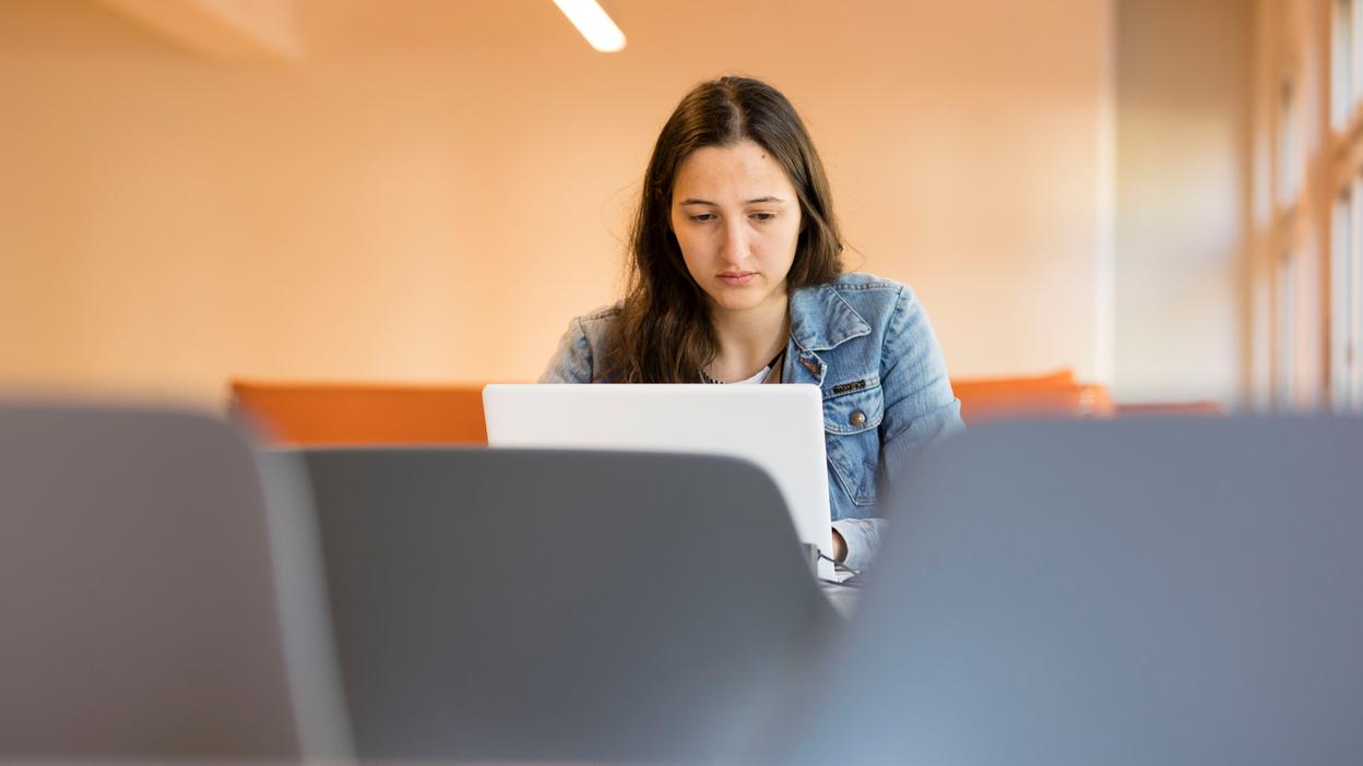 Student working on a laptop while using the University of St.Gallen career platform by Career & Corporate Services.